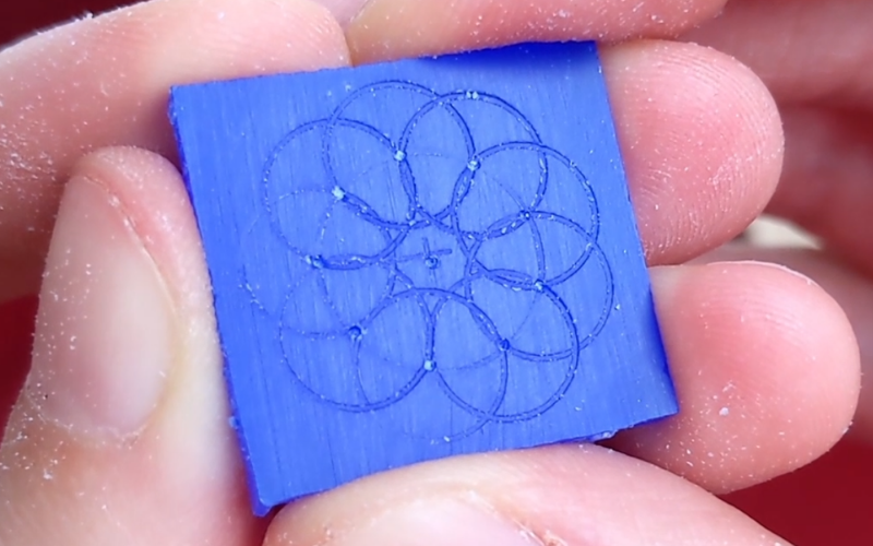 Slice of blue wax with all the circles marked that's the basis for the flower shape