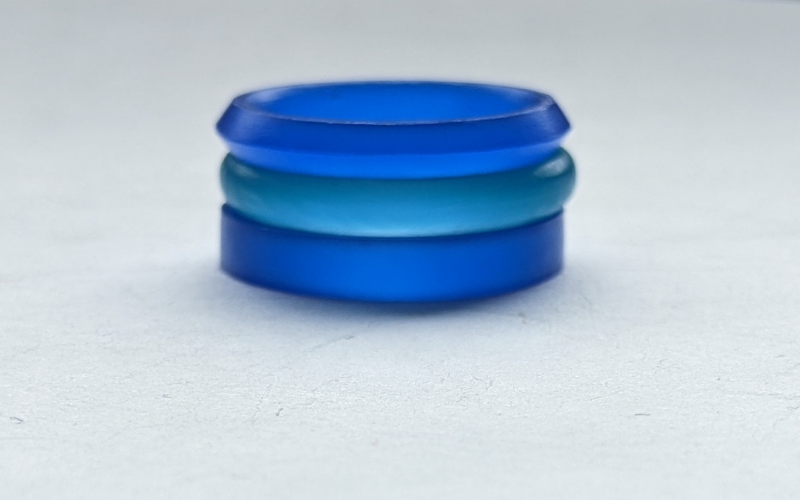 3 wax rings stacked on top of each other, blue flat ring, turquoise court ring and blue knife edge ring 