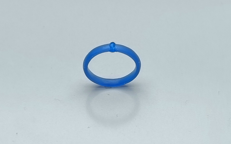 Close up of a blue wax ring with wax melted on top of a break