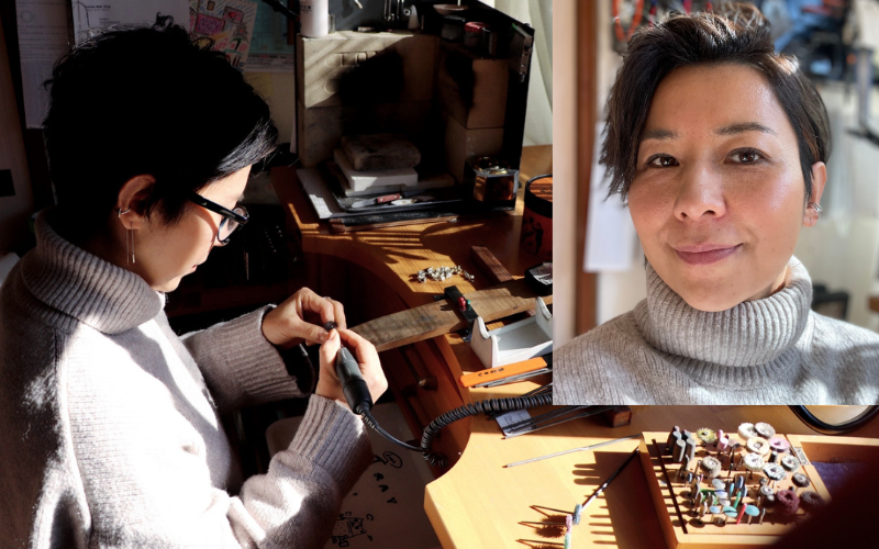 Photo of Anabel Kawai working at her bench with an insert in the top right corner of a different photo so you can see her face. Anabel has short dark hair and is wearing a grey turtleneck sweater
