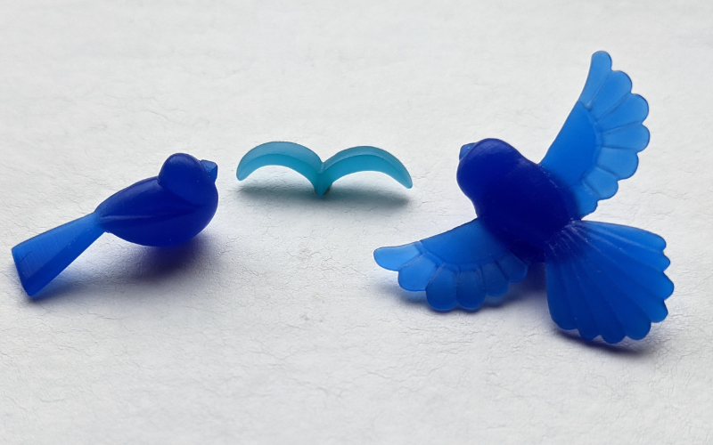 3 birds from blue wax in different stages of complexity