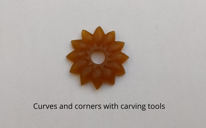 Gold wax carved into shape with carving tools, There are both curves and sharp corners