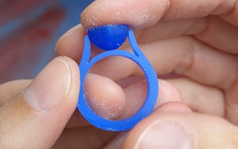 Close up of blue wax ring, cathedral setting style, with a blue wax setting in its place
