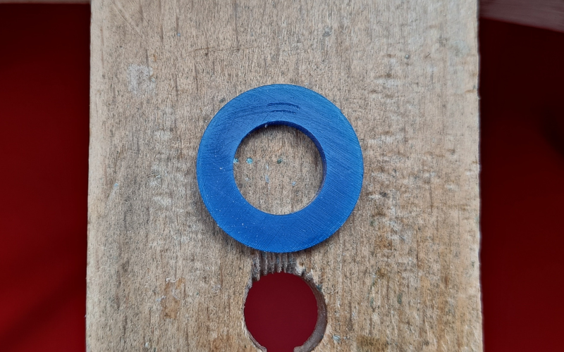 Close up of piece of blue ring tube with small different lines marked on it 