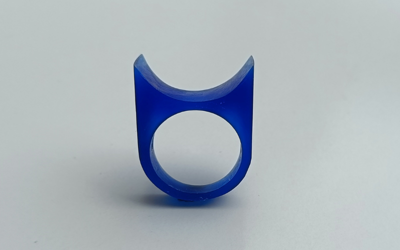 Blue wax ring where the top resembles a half pipe
