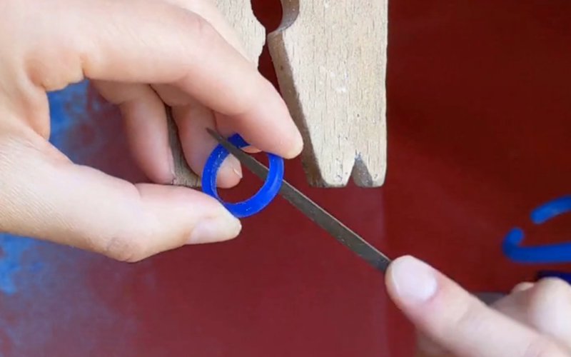 Hands on a bench peg filing a comfort fit