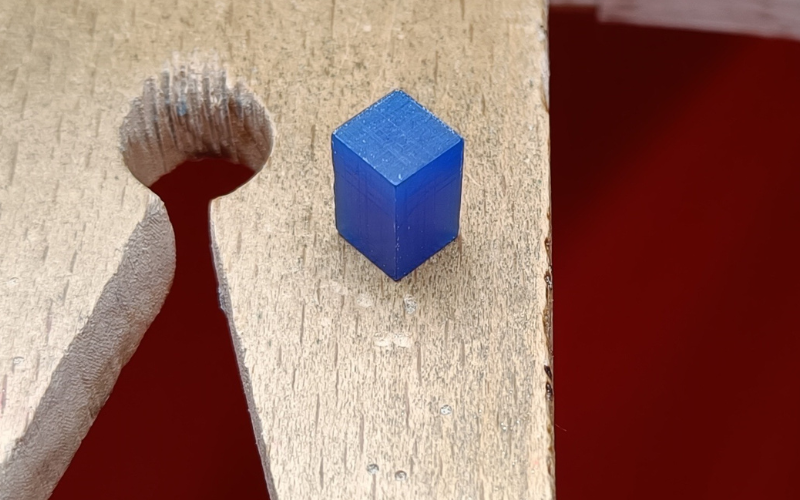 Bench peg with a blue wax cube on top 