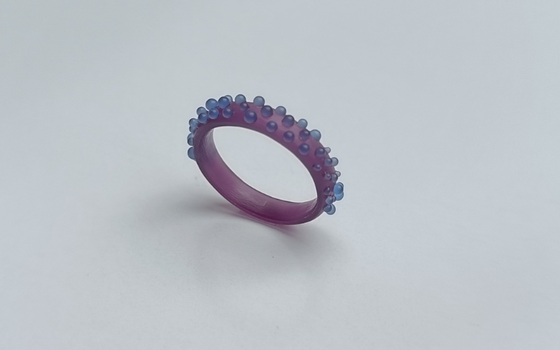 A court shaped ring from purple wax with blue granulation