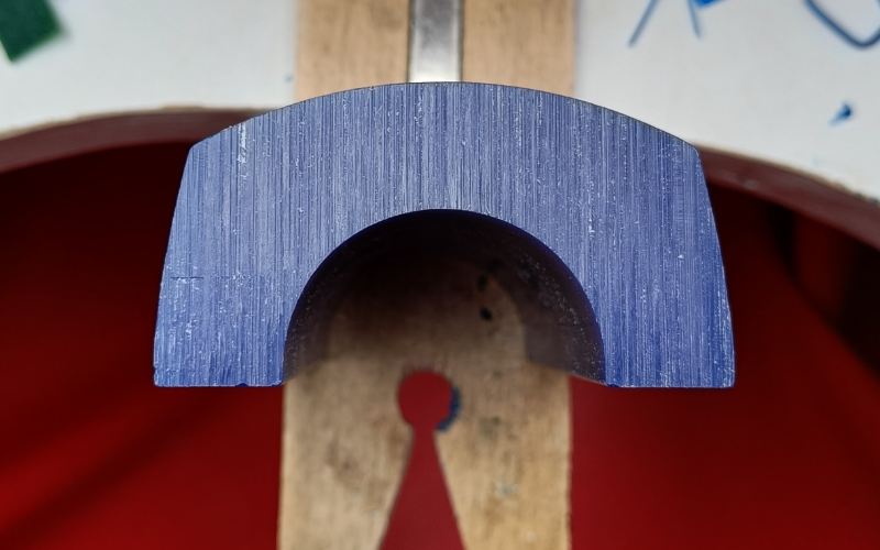 Close up of blue half bangle wax. It's shaped kind of like an arch