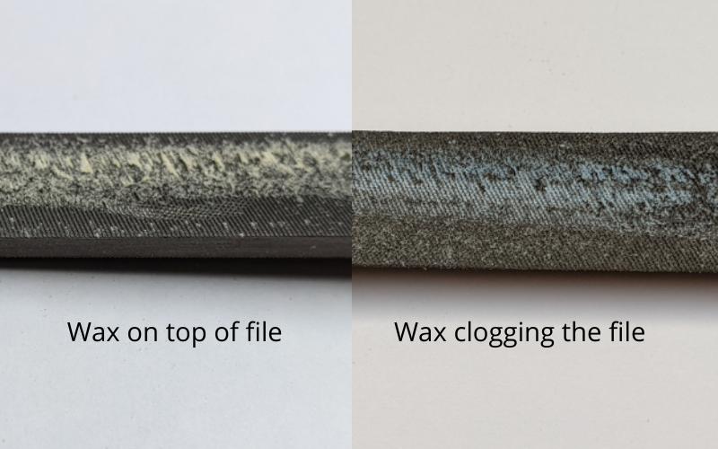 Handfile with gold wax dust lying on top and handfile with blue wax dust clogging the file 