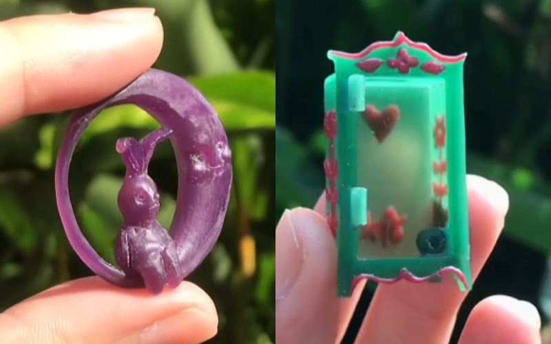Side by side photos. Left fingers holding a piece of round purple waxed carved as a moon with a hare sitting inside. Right fingers holding a closet made from green wax you can see detailing in red wax on the side and back through the wax 