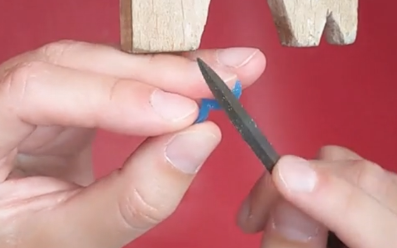 Close up of hands working on a very small piece of wax