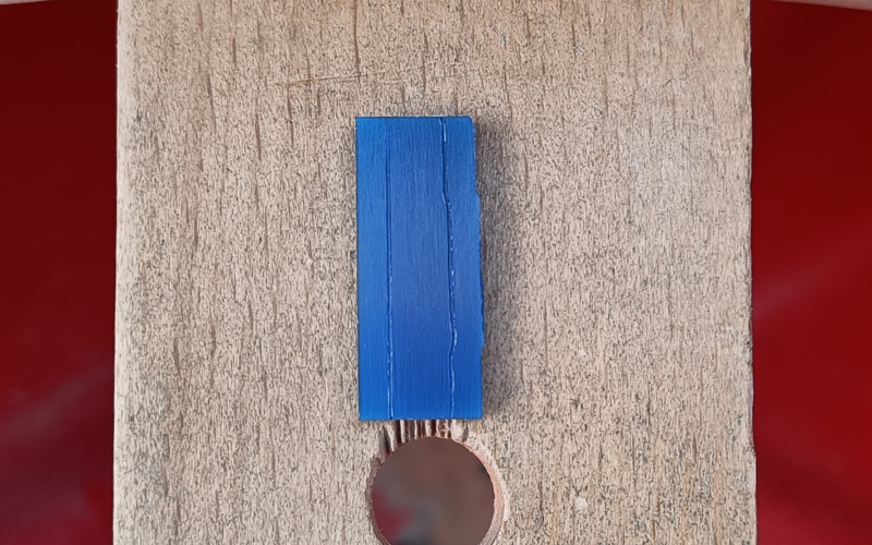 rectangle of wax with lines marked on them. Left line is straight, measured from a straight edge. Right line has some bumps marked from a crooked edge. 