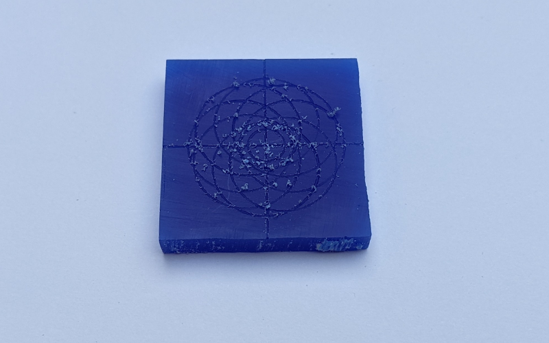 Blue wax with pattern marked on it with loads of dust still on the edges