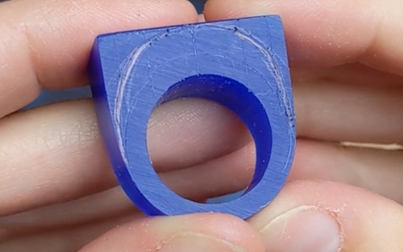 Wax ring blank with marked lines and a drawn line connecting the two 