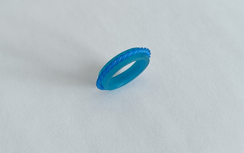 Turquoise wax ring with a band of twisted wax wire going around it