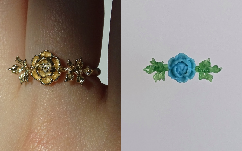 Side by side photo. Left close up of a hand wearing a gold peony flower. The peony and leave cover the finger. Right same piece in wax form. The ring is made from green wax and the flower from turquoise injection wax