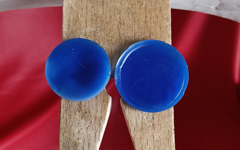 Close up of bench peg with 2 round blue wax slices on top