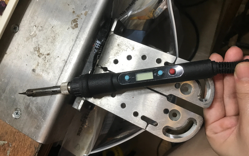 Close up of a benchpeg with a black soldering iron on top