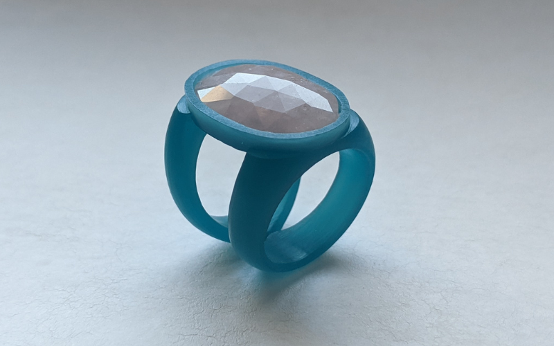 Split shank ring from turquoise wax with an oval pink stone.