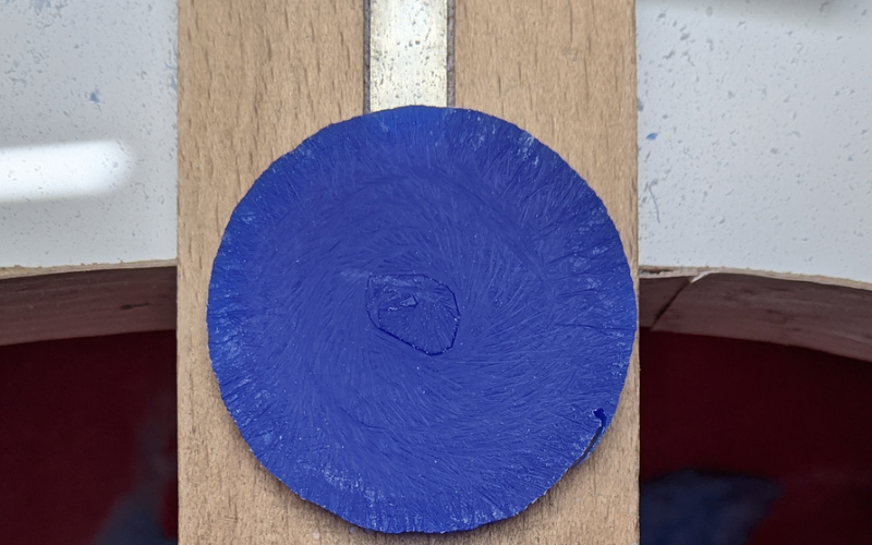 Close up of a piece of blue circular wax. It's the inside of a sized bangle