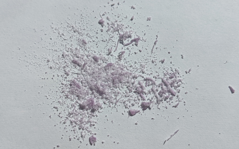 Purple wax dust from piercing
