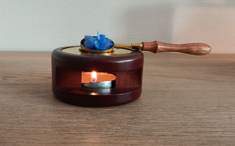 Wax seal melter, the spoon is filled with blue wax scraps